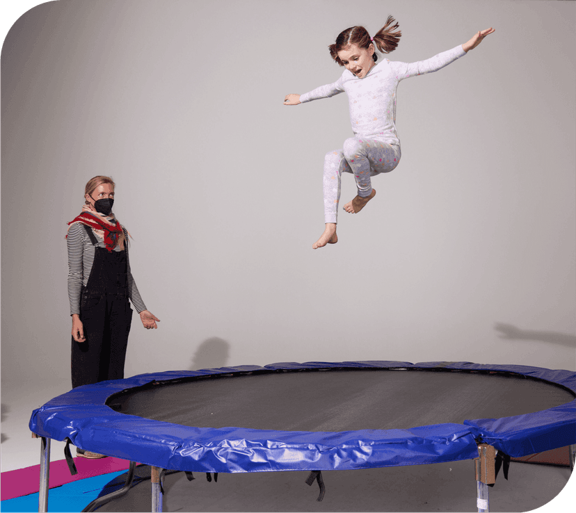 Child jumping on trampoline during photoshoot
